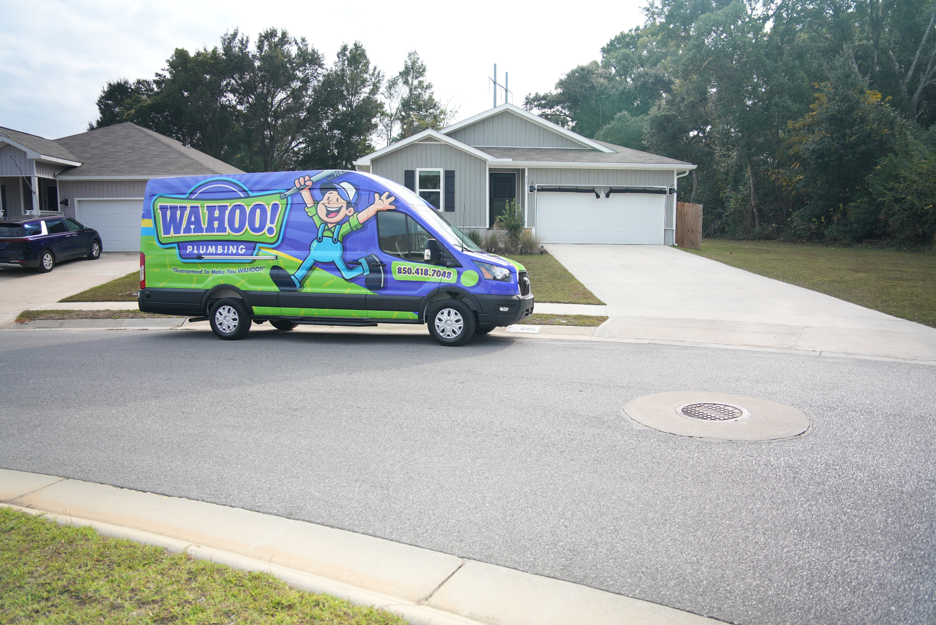Wahoo Plumbing van at a customer's home